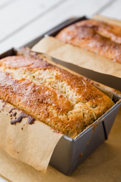 two baked banana bread loaves in a loaf pan
