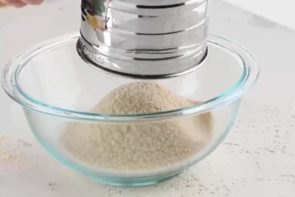 sifting keto flours in a small bowl