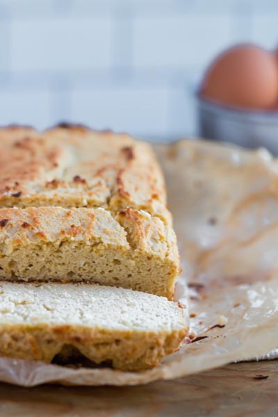 slices of egg loaf on a cutting board with an egg in the background