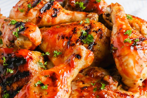 close up of bbq chicken legs with grill marks