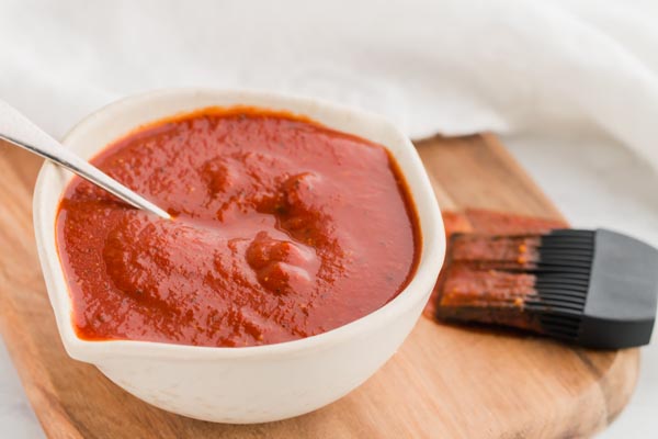 keto bbq sauce in a small bowl with a spoon