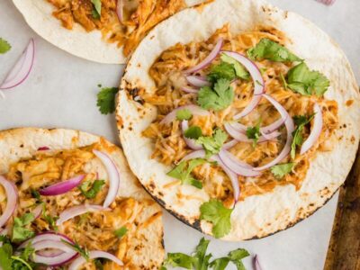 three tostadas layered and staggered on top of each other and topped with onions
