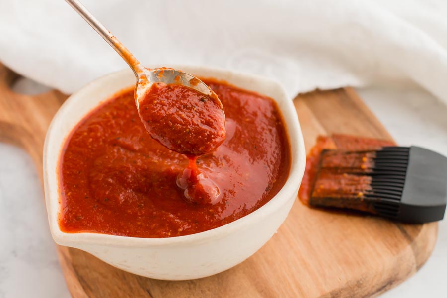 spoon dripping sweet and tangy low carb bbq sauce