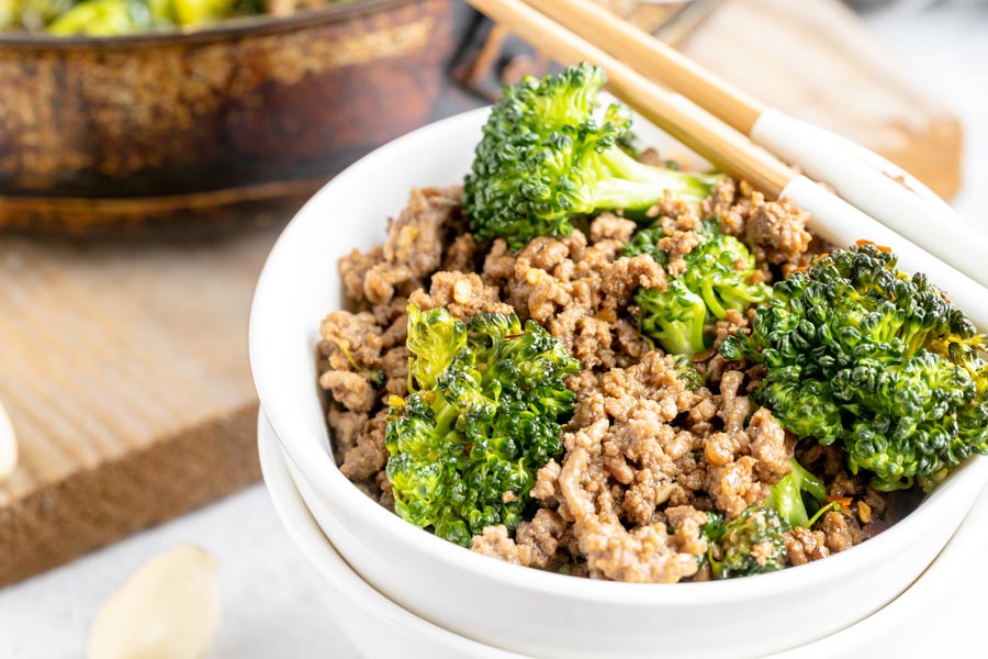 two stacks white bowls with beef and broccoli inside