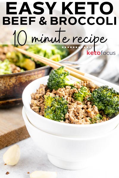 a bowl of beef and broccoli with two garlic cloves in front