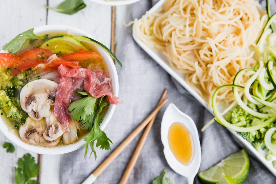 lots of vegetables layered on top keto soup with noodles and sauce neart