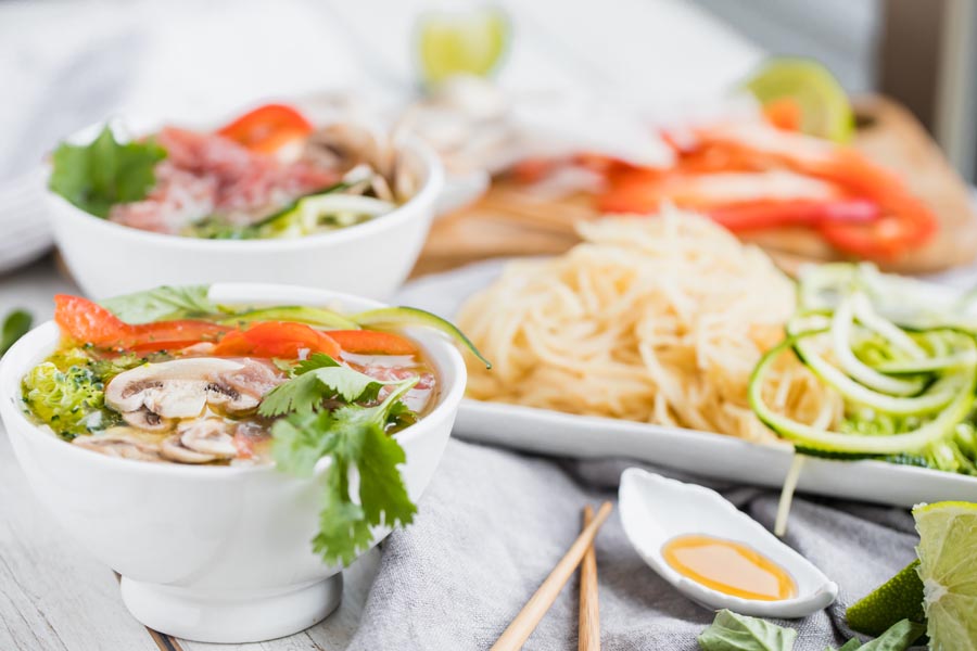 bright display of keto pho with hearts of palm noodles and zoodles in the side