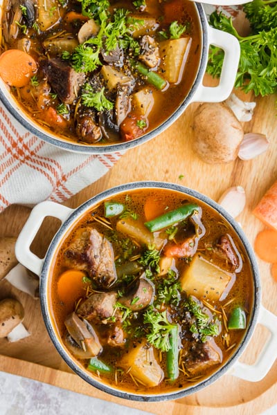 Chunky keto beef stew with big chunks of daikon radish instead of potatoes. Beef, carrot, green beans and parsley are in the soup broth too.