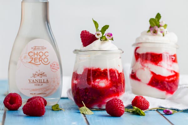 two berry fool parfaits with vanilla choczero nearby