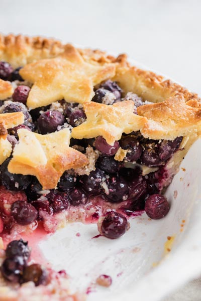 a slice taken out of a blueberry pie