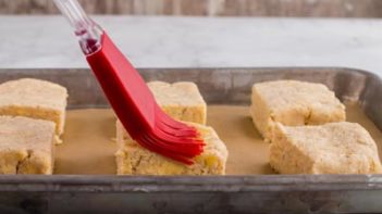 six biscuits on a parchment lined baking sheet