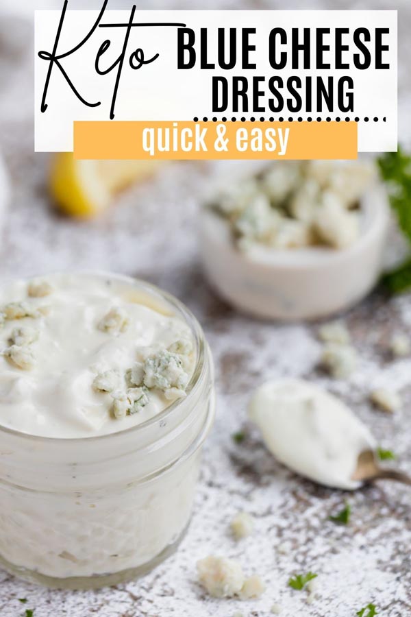 a container of blue cheese dressing next to crumbled of blue cheese and a spoon