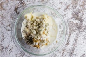 crumbled blue cheese and mayonnaise in a glass bowl