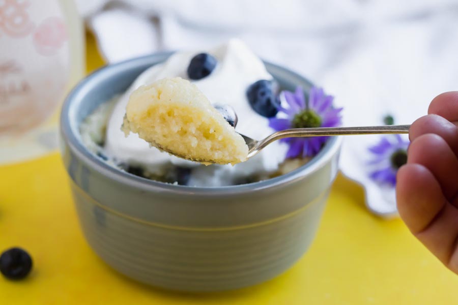 a spoonful of shortcake in front of a mug cake