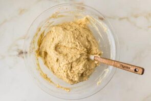 Smooth keto cake batter fully mixed and ready to be divided between prepared cake pans.