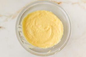 Homemade vanilla custard filling in a glass bowl, cooled and ready for assembling the Boston cream pie.