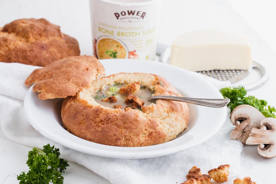 keto soup inside a gluten free bread bowl with spoon