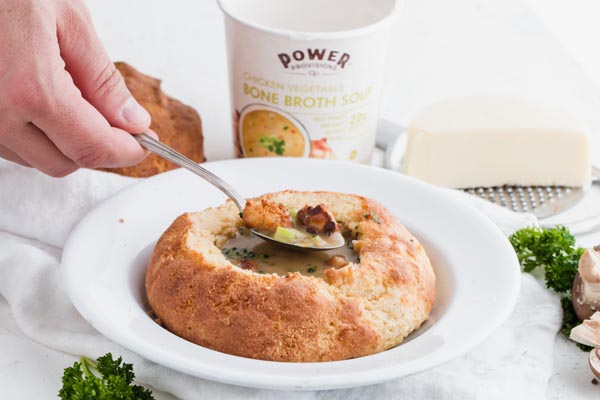 spoonful of keto soup from a bread bowl