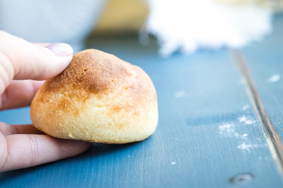 holding a fluffy keto roll