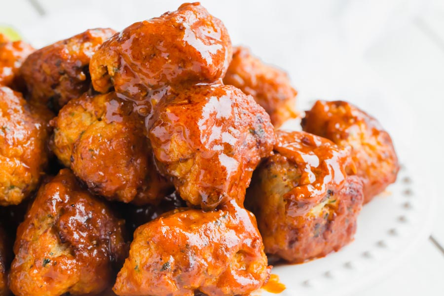 keto buffalo sauce drizzled over chicken meatballs