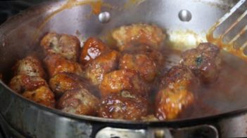 buffalo sauce simmering in a skillet