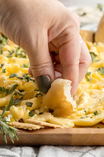 scooping butter onto a piece of low carb bread