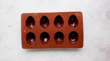 a silicone egg mold with chocolate painted inside