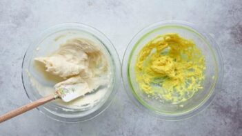 two bowls, one with a white filling and a spatula in it and one with yellow filling