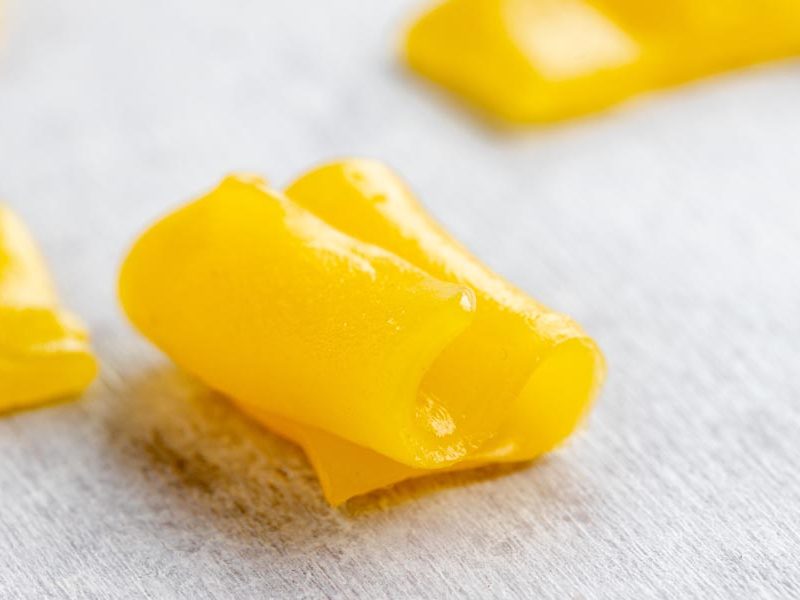 a yellow piece of keto laffy taffy folded on itself