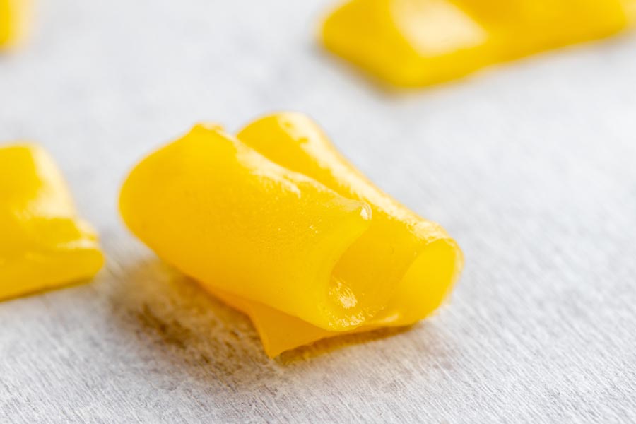 a yellow piece of keto laffy taffy folded on itself