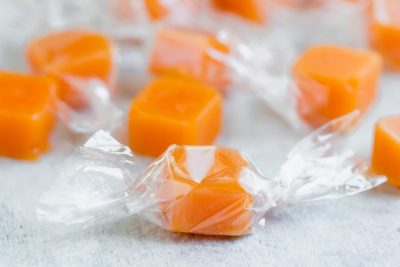 orange colored candy wrapped in cellophane