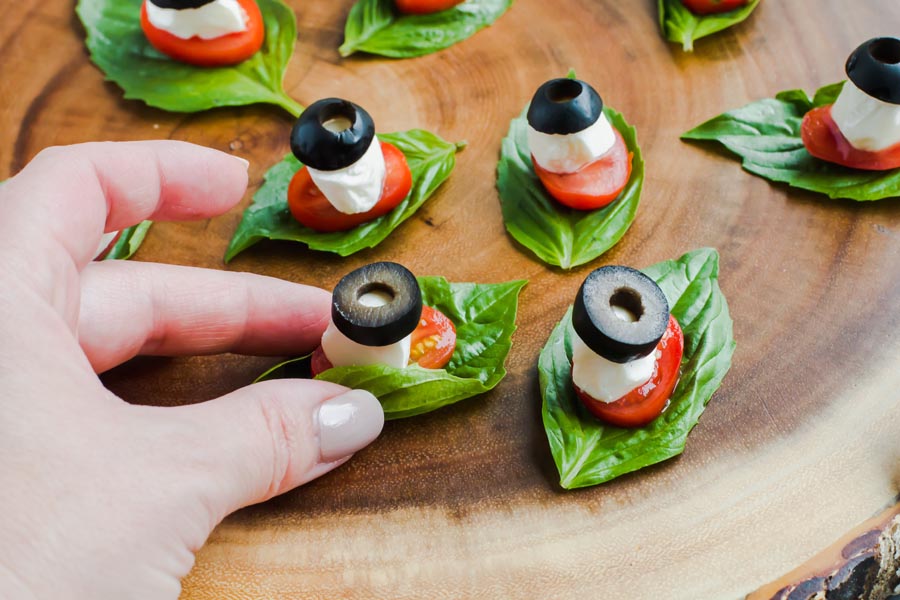 hand picking up a low carb caprese bite