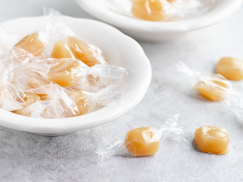 a bunch of wrapped caramels in a bowl