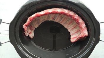 ribs sitting in a slow cooker