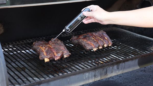 check rib temperature with a meat thermometer on a traeger grill