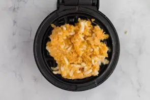 adding carnivore waffle mixture to waffle iron