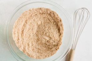 a clear bowl with dry almond flour ingredients inside