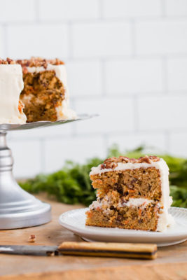 a slice of low carb carrot cake next to a cake stand