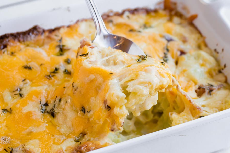 spooning out cheesy gratin