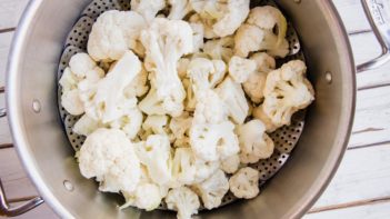 cauliflower florets in a steamer basket