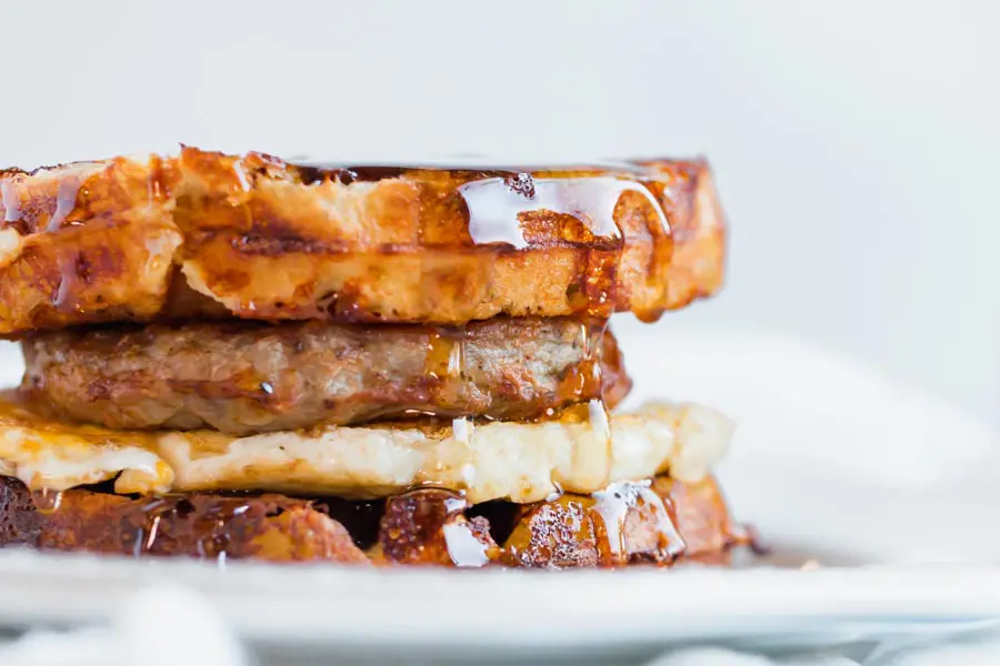 maple syrup dripping from a keto breakfast sandwich