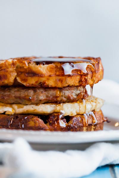 syrup dripping down form a breakfast sandwich made from waffles