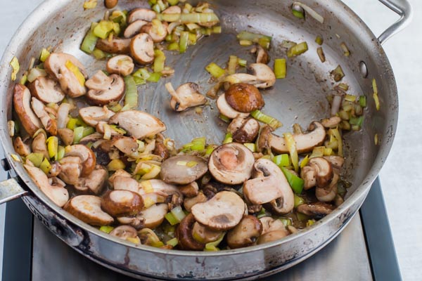 mushroom and leeks cooked in a skillet