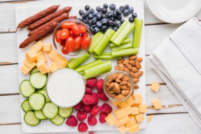 a platter with associated fruits, cheeses and veggies for the kids