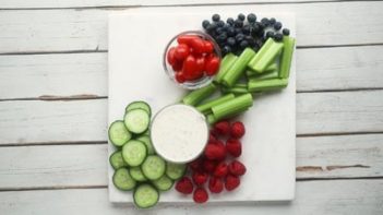 fresh vegetables and fruits on a white board