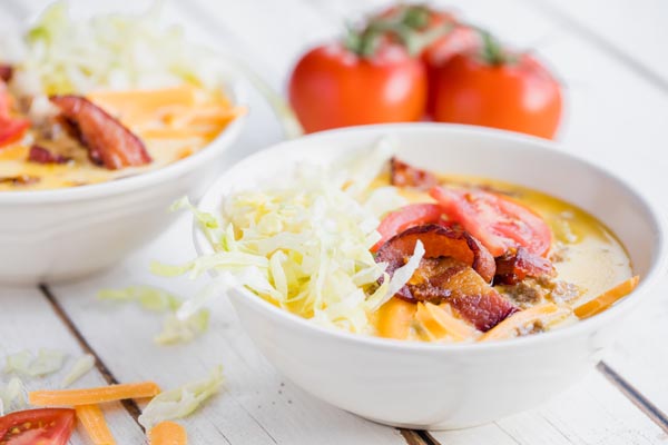 two bowls of creamy soup with bacon on top