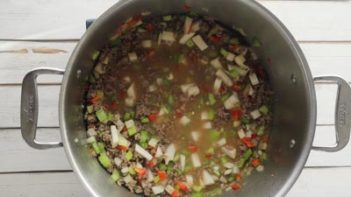 ground beef, vegetables and broth in a dutch oven