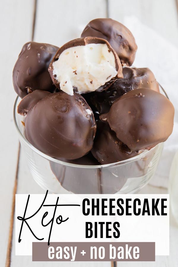 cheesecake bites coated in chocolate in a dish with one half eaten