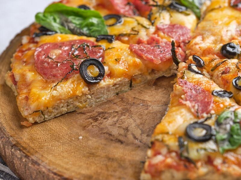 Closeup of the chicken crust from the cheesy pizza.