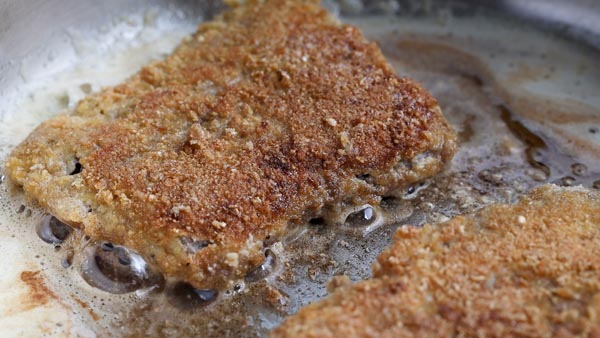 crispy coated chicken fried steak in a skillet frying
